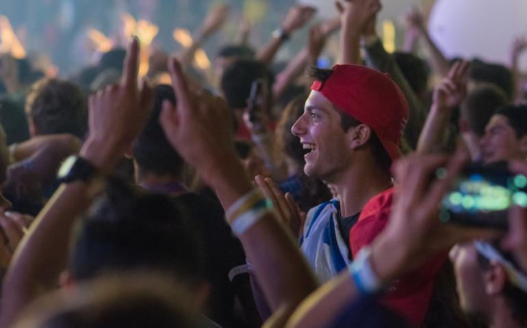 Focus on a teen smiling in a crowd