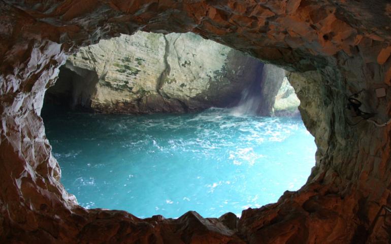 Glimpse of standing body of water through a cave hole