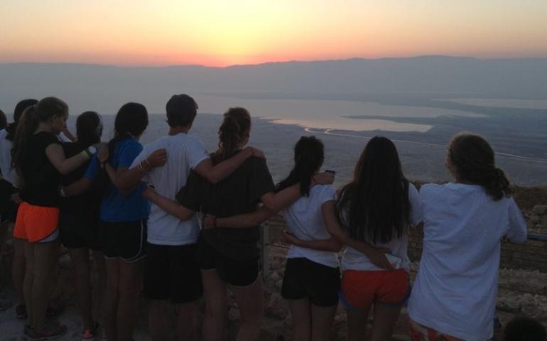 Teens watching the sunrise at Masada