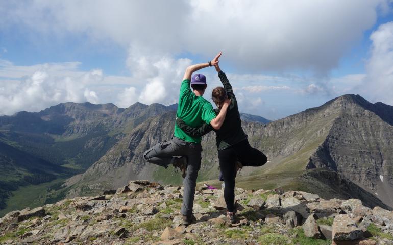 Two campers holding a yoga pose together on the Continental Divide